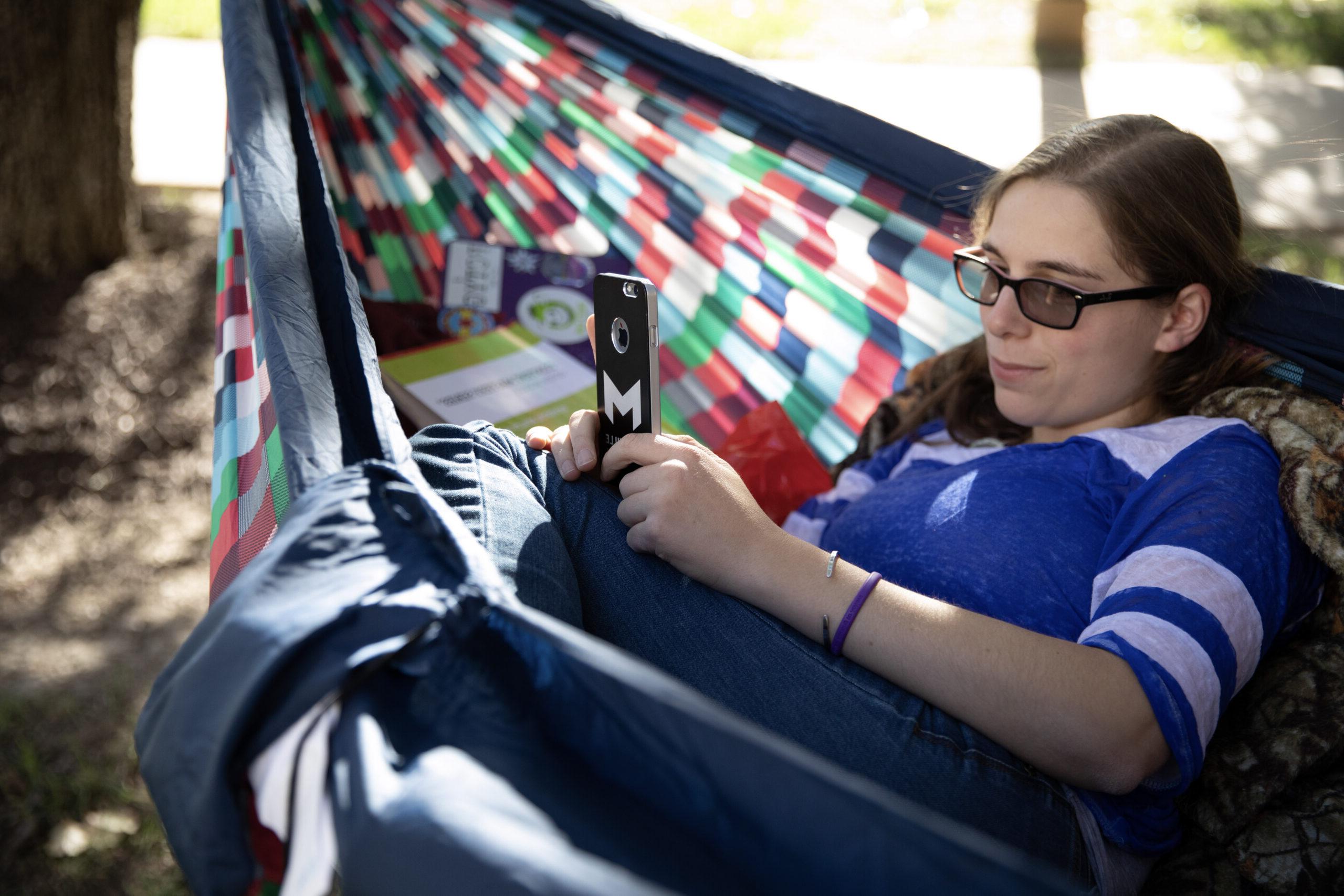 Student relaxing in hammock